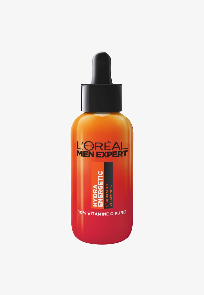 Le sérum L'Oréal Men Expert HYDRA ENERGETIC dans un flacon en verre dégradé orange avec un compte-gouttes noir et un étiquetage audacieux en noir et blanc.