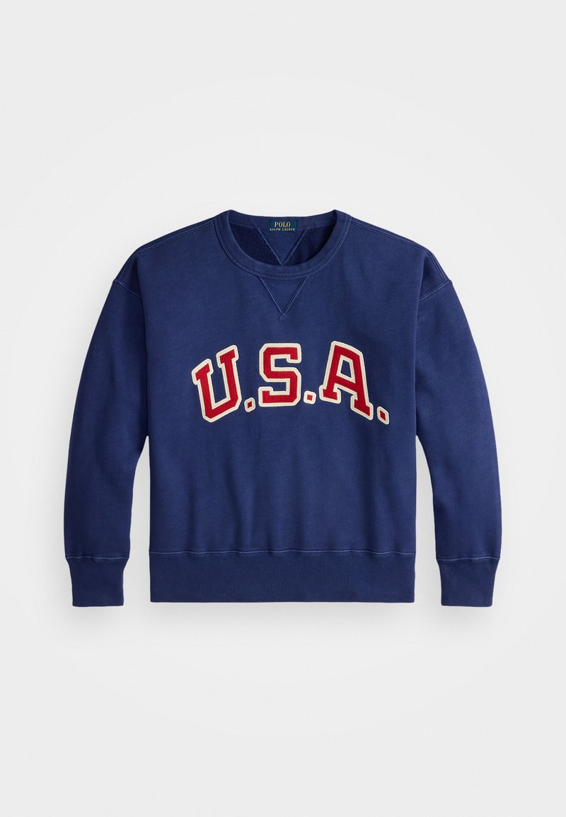 Tume sinine dressipluus pikkade varrukatega, ümmarguse kaelusega ning ees punase ja kreemika "U.S.A." graafikaga. Ribiga mansetid ja äär.