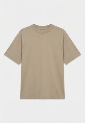 T-shirt beige uni à manches courtes et col rond, posé à plat sur un fond blanc, sans motifs ni logos visibles.