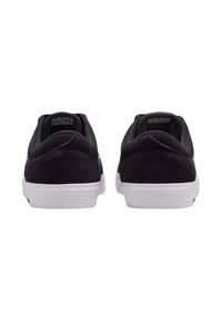 Black suede low-top sneakers with white rubber soles, featuring a smooth finish and minimalistic design. Rear view shows padded collar and branding.