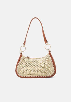 Small handbag with woven cream front panel, brown leather trim, circular gold rings, and a single brown leather shoulder strap.