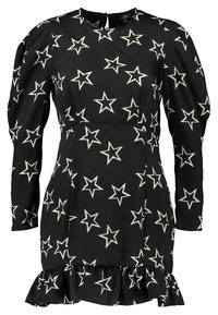 Svart klänning med långa ärmar och rund halsringning. Har ett krämfärgat stjärnmönster och volangkant. Tillverkad av ett mjukt tyg.