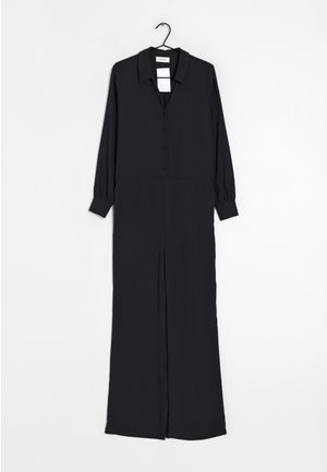 Black long-sleeve jumpsuit with collar and buttons down front, hanging on black hanger against white background.