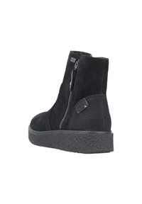 Bottines en cuir suédé noir avec une semelle en caoutchouc noir texturé. Elles comportent une fermeture éclair sur le côté et un talon lisse et plat.