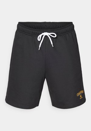 Sorte bomulds-shorts med elastisk talje, hvid snøre og et gyldent "Champion"-logo på nederste højre side.
