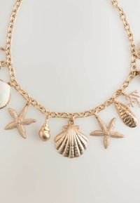 Next SHELL CHARM - Kaulakoru - gold tone