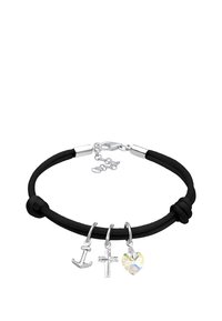 Svart kordarmband med tre silversmycken: en ankare, ett kors och en hjärtformad kristall, säkrad med en silverklämma och kedjeutvidgning.