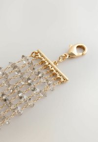 Gold-colored chain with clear crystalline beads, featuring a polished lobster clasp and a rectangular link design, creating a layered effect.