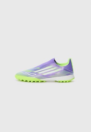 Purple and green soccer cleat with a textured upper, fitted design, and rubber spikes on the outsole for traction.