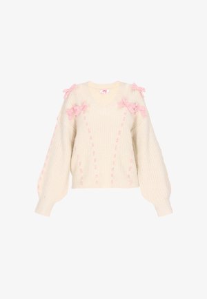 Strickpullover in Creme mit V-Ausschnitt, der mit rosa Wollschleifen an den Schultern und vertikalen Nähten für Textur und Design verziert ist.
