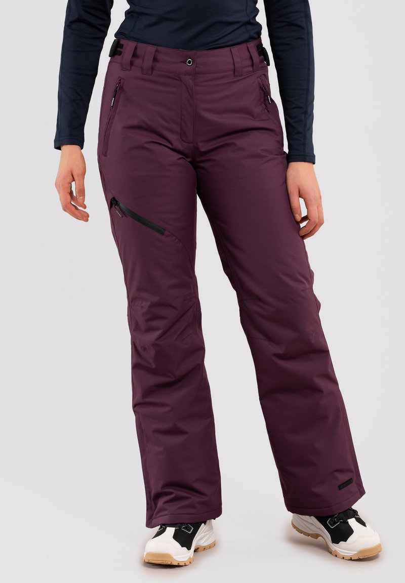 Ski-broek in diep paars, met twee voorzakken en een ritszak op de zij. Gemaakt van een waterdicht materiaal met een rechte pijpdesign.