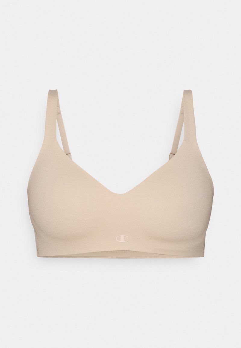 Sottoveste wireless beige con texture liscia, design a scollo a V, spalline regolabili e un logo sottile sul davanti. Materiale senza cuciture e leggero.
