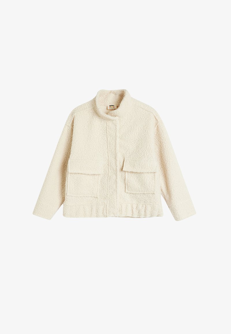 Cream-colored, plush fleece jacket with a stand collar, front snap closure, and two large chest pockets, featuring a textured surface.