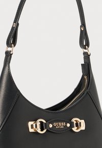 Black synthetic handbag with a smooth texture, featuring a curved shape, gold hardware accents, and a brand logo detail.