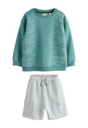 Teal sweatshirt with large white "BAKER" text, paired with light gray shorts featuring cargo pockets and a drawstring waist.