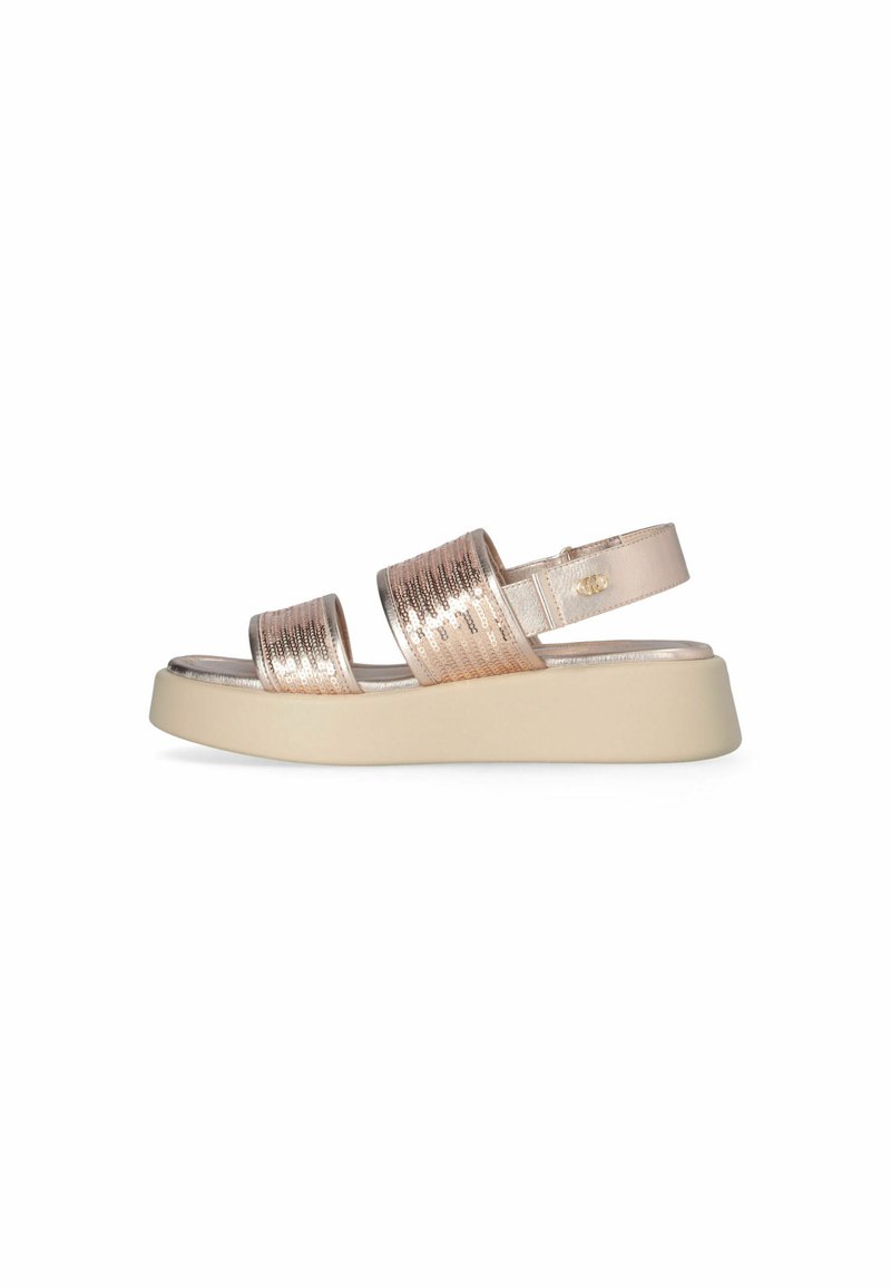 Strappy sandal with metallic rose gold upper, textured straps, and a light cream platform sole. Adjustable ankle strap included.