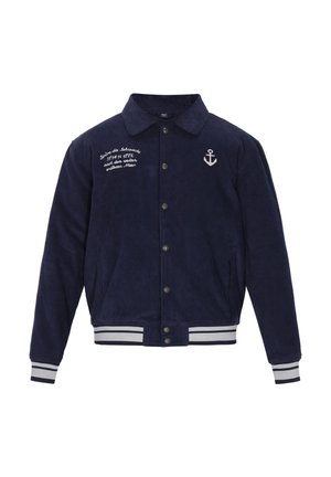 Námornícky kordový kabát s knoflíkovou přední stranou, bodovým límcem, vyšívaným detailem kotvy, bílými pruhy na manžetách a spodním lemu a bočními kapsami.