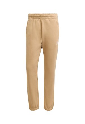 Beige sweatpants with an elastic waistband and cuffs, featuring a white logo accent on the left leg. Fabric is soft and smooth.