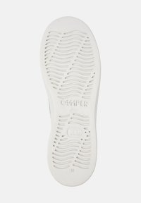 White rubber shoe sole with wave patterns, featuring "CAMPER" logo and size "36" embossed. Textured for grip and stability.