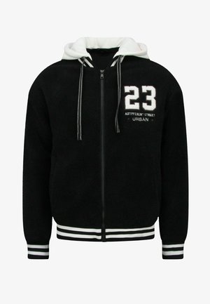Zwarte hoodie met ritssluiting, gemaakt van een knusse, gestructureerde stof, wit gevoerde capuchon en gestreepte manchetten. Voorzien van het nummer "23" en tekst op de borst.