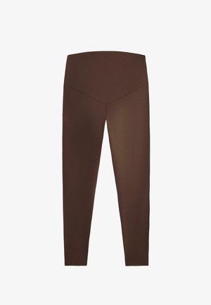 Brązowe legginsy z wysokim stanem, z przeszyciem w kształcie litery V z przodu, wykonane z elastycznego, gładkiego materiału.