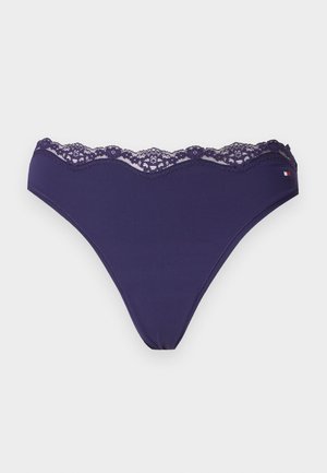 Marineblåt bikinibund til kvinder med blonder langs linningen og et lille rødt, hvidt og blåt logo på højre side.