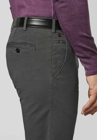 Grijze katoenen chino's met een rechte snit, subtiele textuur, achterzakken met knopen, en een zwarte leren riem in de taille.