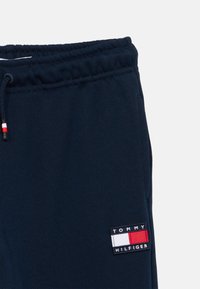 Παντελόνι φόρμας σε ναυτικό μπλε με ελαστική μέση, κορδόνι και ένα σχέδιο με το λογότυπο Tommy Hilfiger σε κόκκινο, λευκό και μπλε. Μαλακή υφή υφάσματος.
