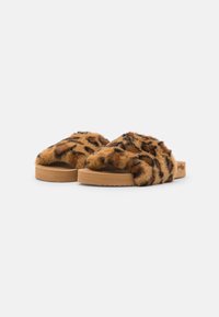 Faux fur slippers with a leopard print design, tan rubber sole, open toe, and soft texture. Rounded shape with a wide strap across the foot.