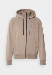 Sweat à capuche beige avec fermeture éclair noire, poche kangourou à l'avant, poignets et ourlet côtelés, et col intérieur factice amovible.