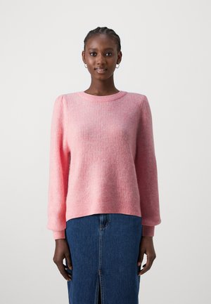 Pink ribbed sweater with long sleeves, round neck, and soft texture. Paired with a blue denim skirt featuring a front slit.