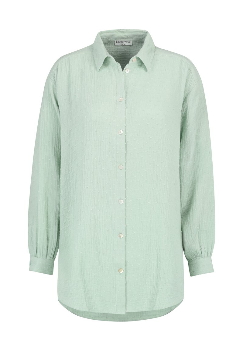 Hellgrünes, langärmeliges Hemd mit Knöpfen aus strukturiertem Stoff, ausgestattet mit einem Hemdkragen und einem abgestuften Saum mit fünf Knöpfen.
