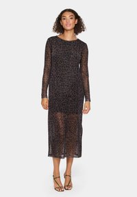 Sheer black dress with a leopard print, long sleeves, round neckline, and mid-calf length. Subtle texture and lightweight fabric.