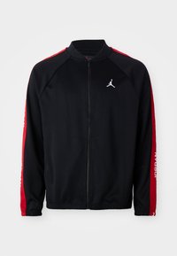 Black zip-up sports jacket with red stripes on sleeves, elastic cuffs, and white Jumpman logo on the left chest.