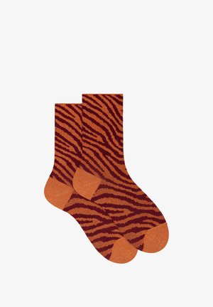 Orange socks with a tiger stripe pattern in shades of dark maroon. Features reinforced toes and heels. Soft texture, ribbed tops for fit.