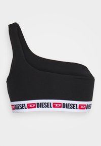 Bralette noir à une épaule fabriqué en matériau doux, avec une large bande blanche ornée d'accents rouges et noirs du logo "DIESEL".