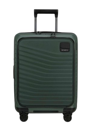 Valise rigide vert foncé avec poche zippée à l'avant, poignée télescopique, quatre roues, et logo Samsonite en haut à droite.