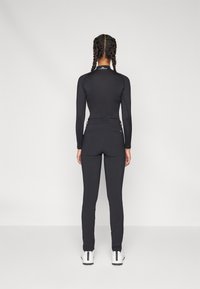 Kjus WOMEN WARM STRETCH TREGGINGS - Auduma bikses - black