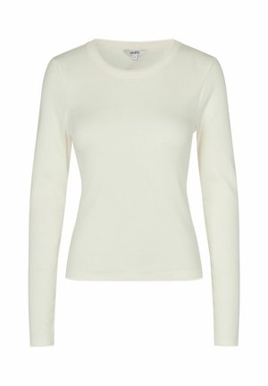 Biela priliehavá košeľa s dlhým rukávom a okrúhlym výstrihom v slonovinovej farbe s jemným vlnitým lemovaním na výstrihu, manžetách a leme.