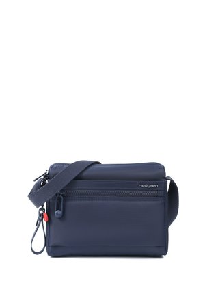 Navy blue Hedgren crossbody bag with front zipper pocket, adjustable shoulder strap, and small key ring attachment on white background.
