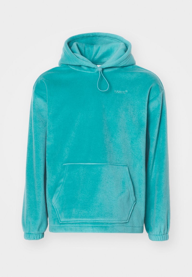 Türkiser Kapuzenpullover mit einem plüschigen Material, frontaler Kängurutasche und elastischen Bündchen. Mit Kordelzug am Ausschnitt.