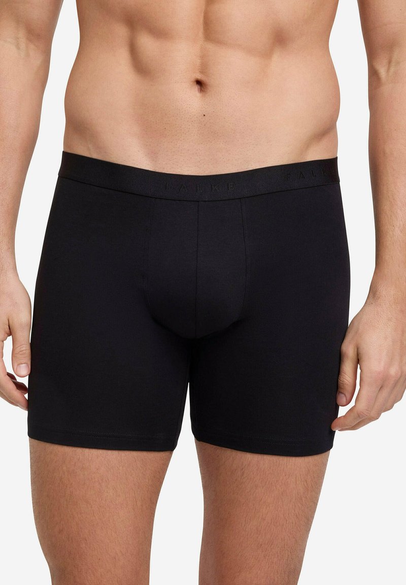 Czarne bokserki wykonane z gładkiego materiału, z logo na pasie, dopasowany fason i długość do połowy uda zapewniająca pełne pokrycie.