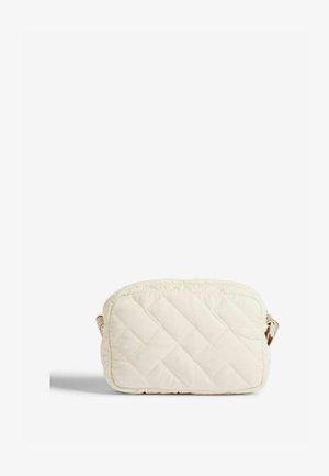 Padedinė, kreminės spalvos quilted rankinė, stačiakampio formos su viena petneša. Yra diagonalių siūlių raštas.