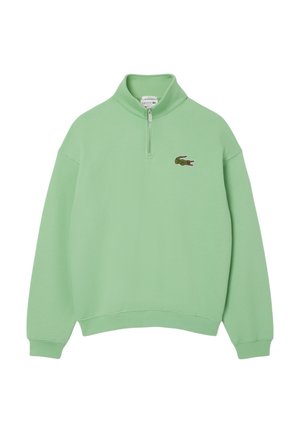 Hellgrüner Langarm-Pullover mit kurzem Frontreißverschluss und kleinem, gesticktem Krokodil-Logo auf der linken Brust.