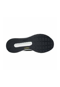 Soletta di scarpa nera con un design in gomma testurizzata e un battistrada profilato. Include una sezione centrale bianca e il logo giallo "Goodyear".