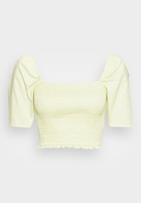 Top cropped amarelo claro com mangas curtas bufantes, textura franzida e bainha com volantes. Feito de um tecido macio e tecido.