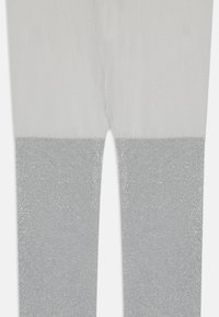 Leggings avec un haut gris clair lisse et une partie inférieure en paillettes argentées scintillantes, offrant une transition sans couture entre les matériaux.