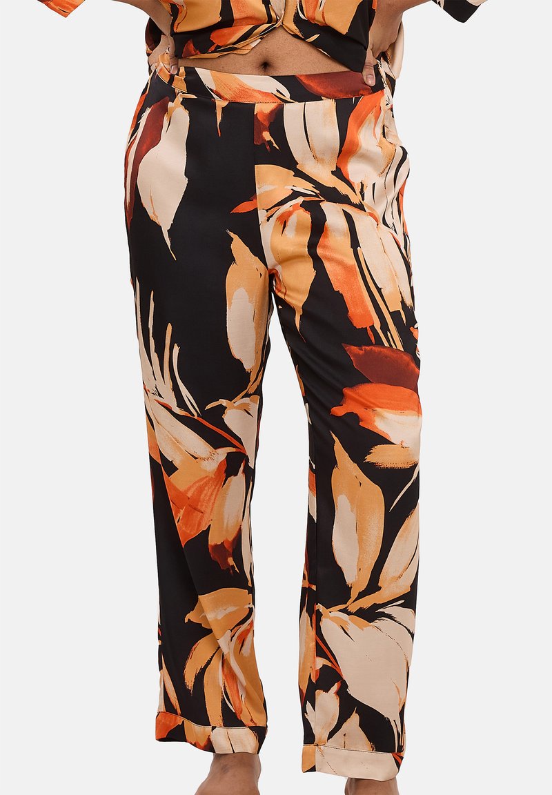Pantalons noirs avec un motif floral dans des teintes d'orange, de crème et de beige. Fabriqués dans un tissu doux, ils présentent une coupe décontractée et une conception arrivant à la cheville.