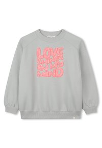 Sweat-shirt gris clair arborant le texte "L'AMOUR RAYONNE DANS MA TÊTE" en lettres roses scintillantes, conçu avec une coupe décontractée et des poignets côtelés.