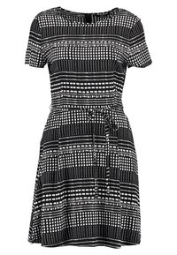 Svart och vit kortärmad klänning med rund halsringning. Har ett horisontellt och vertikalt prickmönster, insvängd midja och utsvängd kjol.